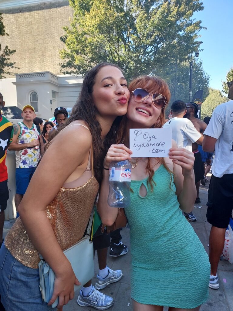 Joy written in sunlight — sisters of spirit carrying Oyaomore through Carnival streets