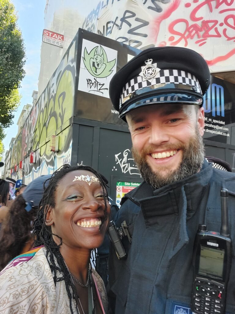 Uniforms and rhythms meet in a shared smile — Carnival holds space for unlikely harmony.