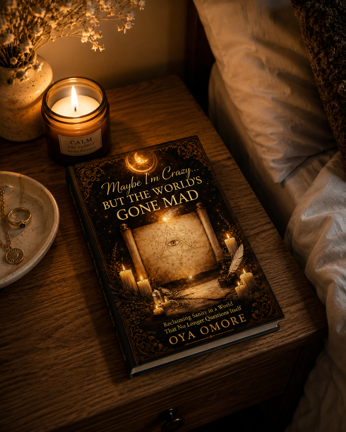 Maybe I’m Crazy… But the World’s Gone Mad on a bedside table beside a candle